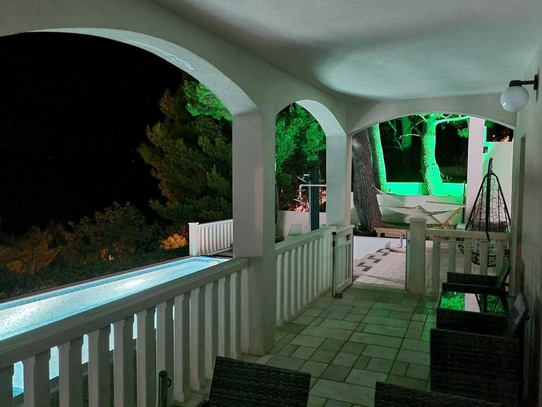 Courtyard and pool at night with green garden lighting, Easy Living, Lokva Rogoznica