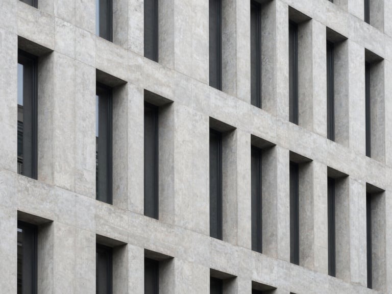 High-angle architectural shot of a modern concrete building facade, sharp focus, desaturated cool tones