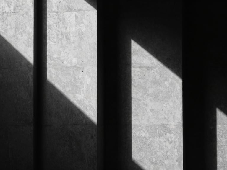 Stark black and white architectural shadow play on concrete walls, minimalist geometry, sharp contrast, cinematic