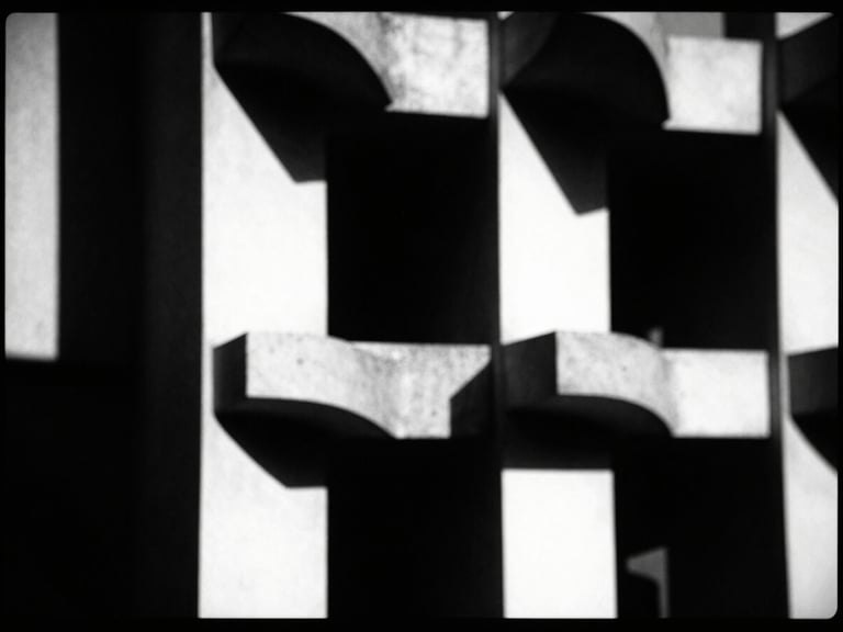 Abstract geometric shapes, high-contrast chiaroscuro lighting, deep shadows, sharp focus, 35mm film