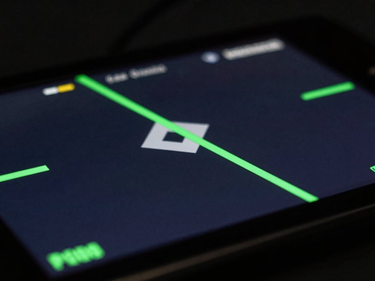 Close-up of a mobile gaming screen rendering rapid 3D geometry, sharp focus, low-key lighting with terminal green key lights