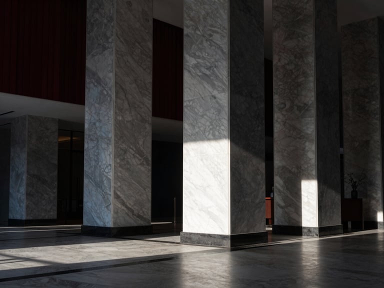 Premium architectural photography of a luxury hotel lobby interior with marble pillars, dramatic shadows, crisp morning daylight, minimalist design, Hasselblad medium format.