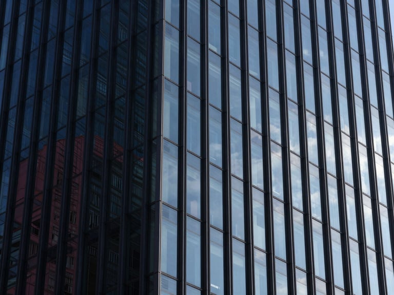 Abstract architectural perspective of steel and glass high-rise facade, sharp morning daylight reflecting deep navy tones, high-contrast composition, Hasselblad medium format.
