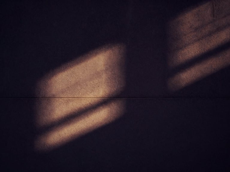 Abstract architectural shadow play on a concrete wall, with a subtle golden light streak, cinematic dark luxury, high contrast