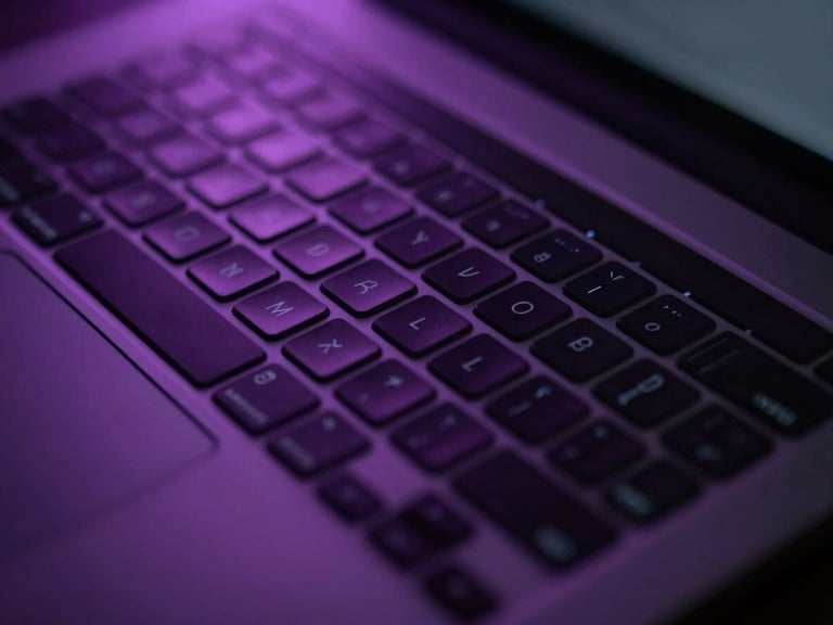 Close-up of a sleek, dark laptop keyboard with glowing keys in a studio setting, soft purple ambient light, high contrast