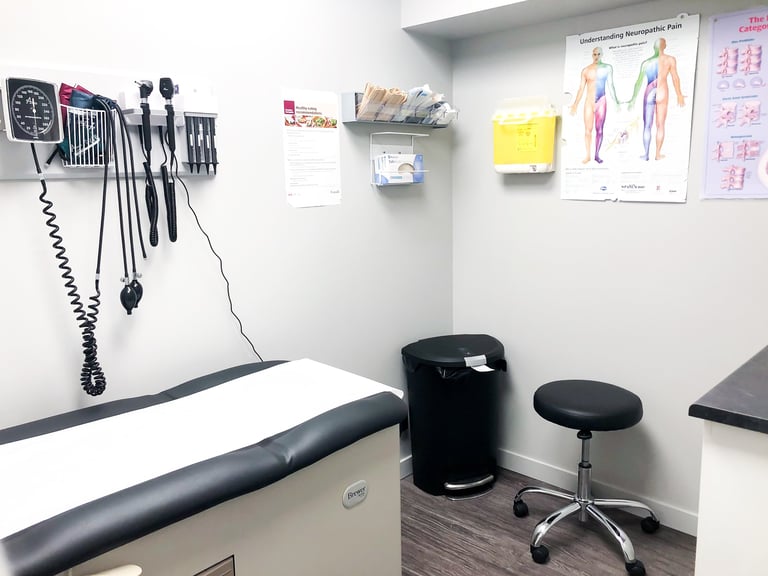 Clean modern medical examination room with exam table and diagnostic equipment in healthcare clinic