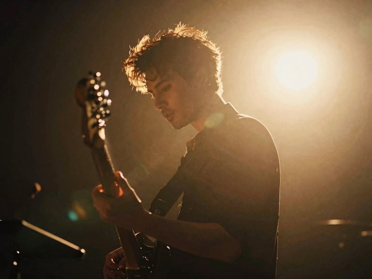 Cinematic film photography of a musician under dramatic backlighting, rich golden-hour natural light, anamorphic lens flare, shallow depth of field.