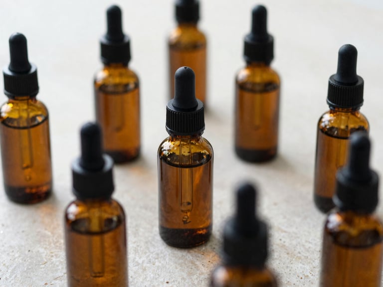 Macro close-up of amber glass dropper bottles filled with botanical tinctures, with dried herbs and compounding tools on a light stone surface, soft natural daylight, 35mm lens