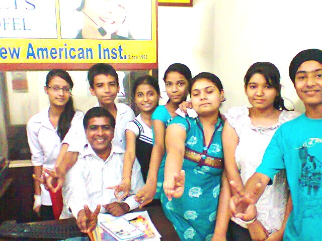 a group of people standing around a desk
