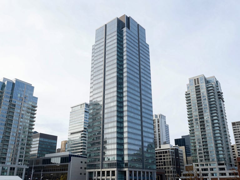 Wide-angle architectural shot of Vancouver downtown glass skyscrapers under bright overcast sky, clean corporate aesthetic, cool blue tones, 35mm lens