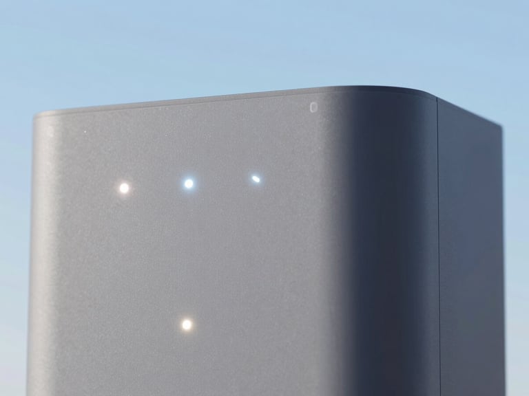 Close-up of a modern smart home hub device with several glowing indicator lights, clean background, crisp focus, 35mm