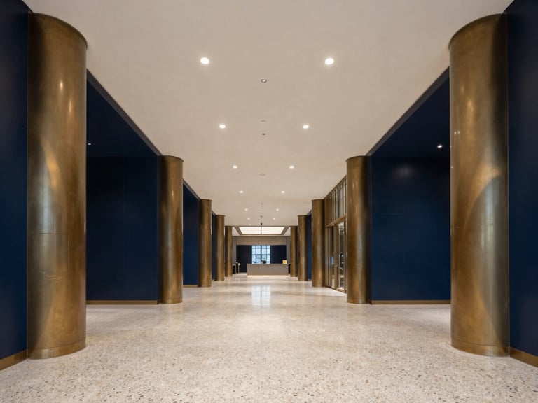 Symmetrical grand commercial lobby with polished terrazzo floors and bronze pillars, crisp interior lighting, 35mm architectural photography