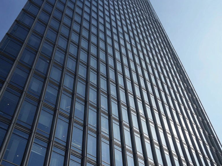 Wide-angle architectural photograph of a modern skyscraper facade design, featuring intricate structural details and sleek glass panels, high-contrast daylight, sharp shadows.