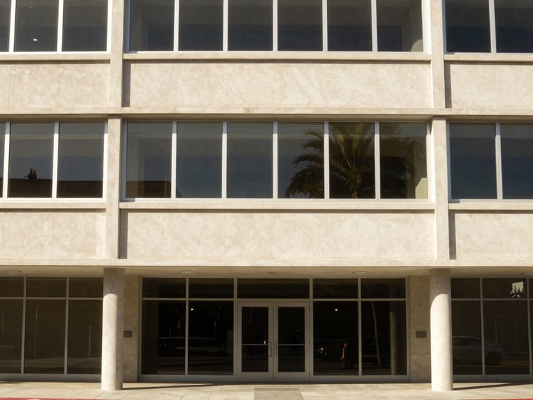 Mid-century modern commercial office building in Southern California, clean architectural lines, bright natural daylight, warm tones.