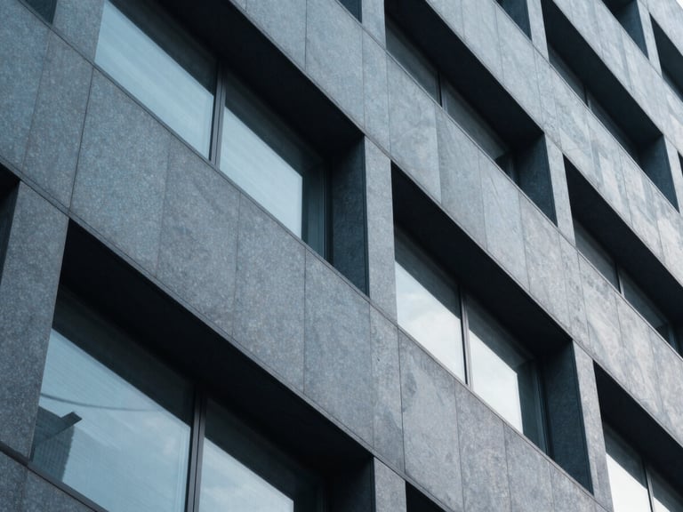 Sleek architectural detail of a modern financial district building, sharp geometric shadows, cool blue and slate tones, 35mm
