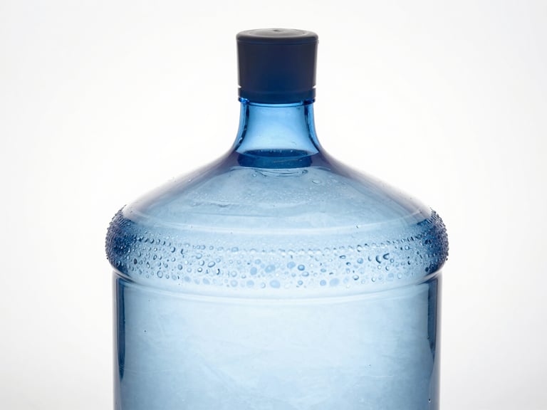 Macro studio photograph of a massive, perfectly spherical 20-litre glass water jar, glowing with subtle internal blue light, sharp metallic cap, clinical white background