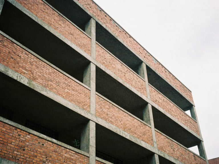 Low angle shot of a brutalist brick building facade in Bogotá, geometric concrete beams, overcast sky, architectural shadow play, 35mm film style