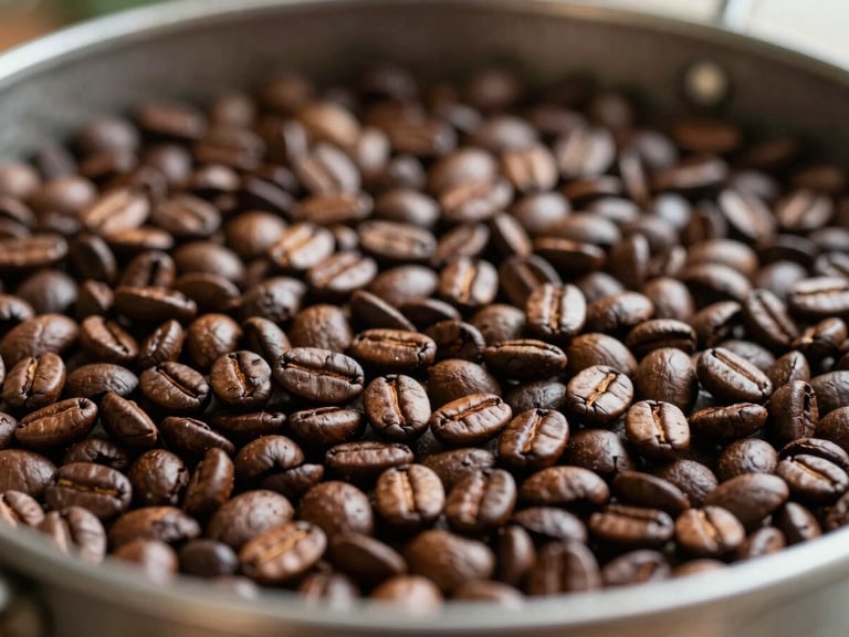 Close-up of roasted coffee beans cooling in a metal roasting tray, rich brown tones, warm natural light, shallow depth of field