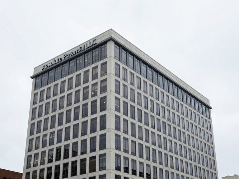 Modern office building in Charlottesville, Virginia, with Absolute Potential LLC branding, clean overcast daylight, 35mm architectural lens