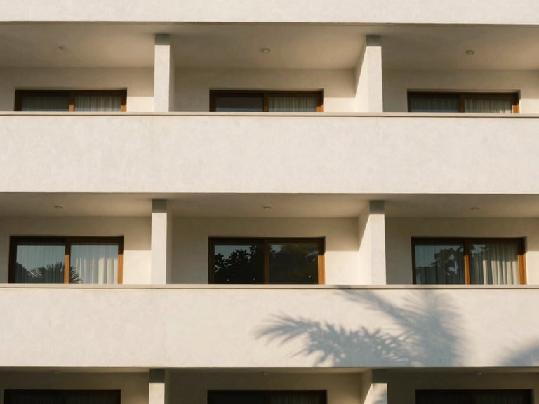 Straight-on architectural photograph of a modern residential facade in Cuernavaca, clean lines, warm sunlight casting structured shadows, 35mm