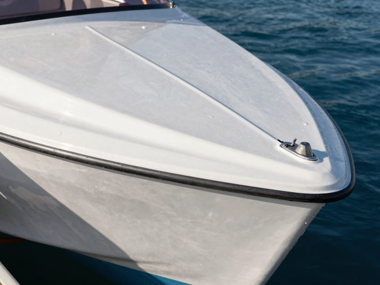 Extreme close-up of water-beading on freshly coated ceramic boat hull, bright direct sunlight emphasizing wet-look gloss and reflection, sharp marine photography, 35mm