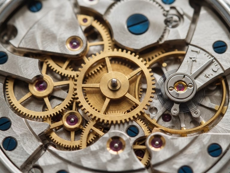 Macro detail shot of golden brass watch gears, clean architectural composition, soft diffused daylight, editorial corporate photography style