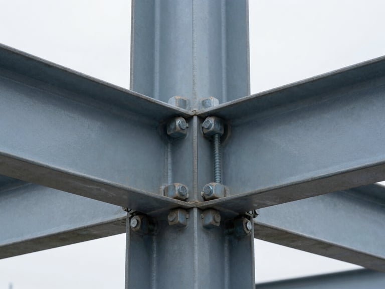 Macro close-up of a heavy steel bolted connection joint, crisp technical photography, cool overcast daylight, sharp focus, 35mm