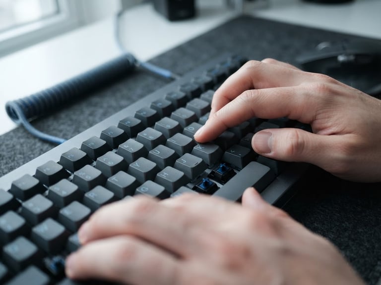 Macro technical photography of hands typing on a mechanical keyboard, cool natural daylight, slate tones, sharp focus, 35mm