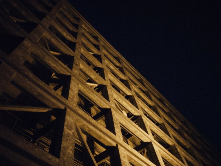 Abstract architectural lines reaching upward into a deep navy starry night, high-contrast golden light cutting through structural steel, 35mm cinematic editorial photography
