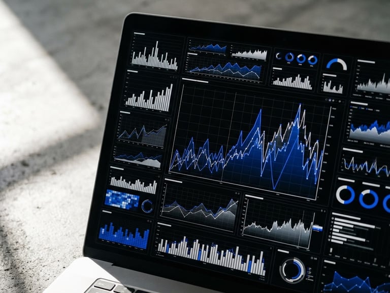 Tight macro shot of a real-time attribution dashboard on a high-resolution screen, bright side-light casting sharp shadows across a clean concrete workspace, cobalt blue data lines.