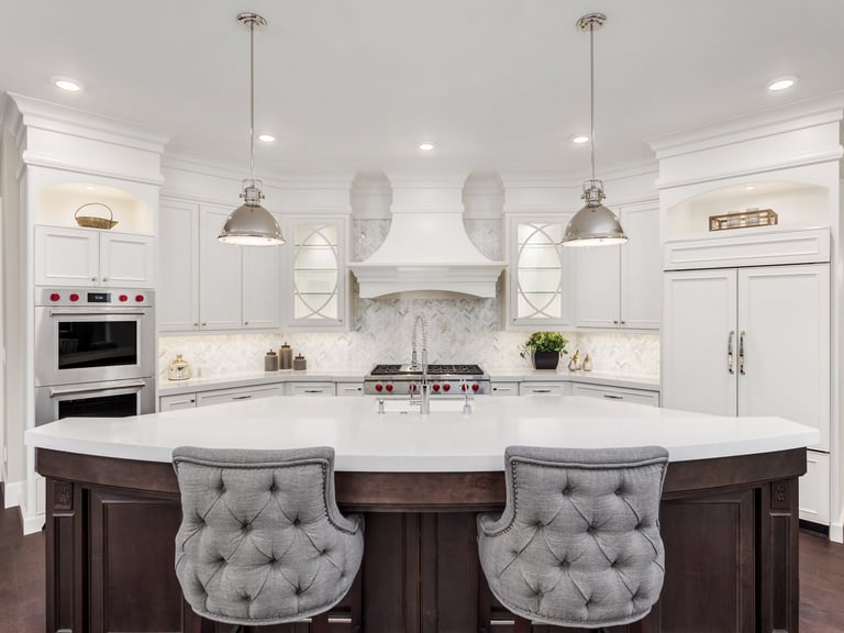 Newly built kitchen featuring custom cabinetry, countertops, flooring, and lighting