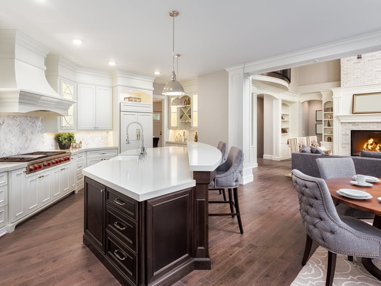 Newly built kitchen featuring custom cabinetry, countertops, flooring, and lighting