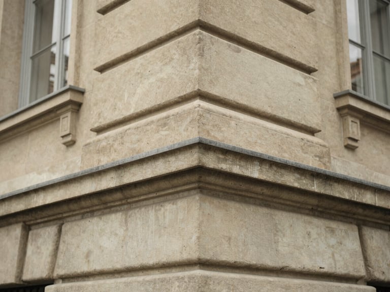 Macro detail of a classic limestone building corner in Geneva, soft overcast daylight, desaturated earth tones, architectural texture, 35mm