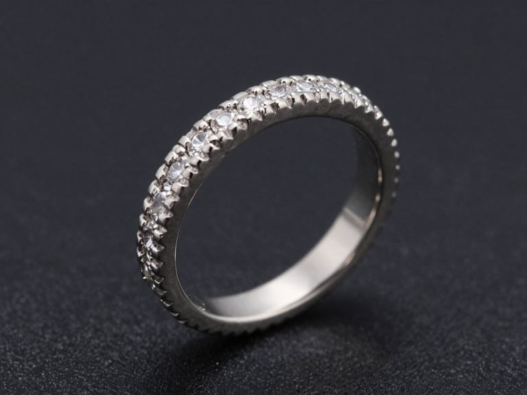 Extreme close-up of a platinum vintage-style engagement ring with detailed milgrain borders and hand-set micro-pave stones, high-contrast studio lighting