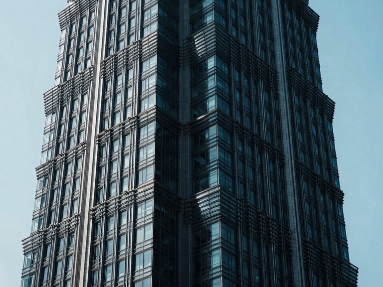 High-contrast chiaroscuro photo of a massive cantilevered steel joint of a modern skyscraper, cool cyan ambient light cutting through deep shadows, ultra-sharp details, 35mm lens