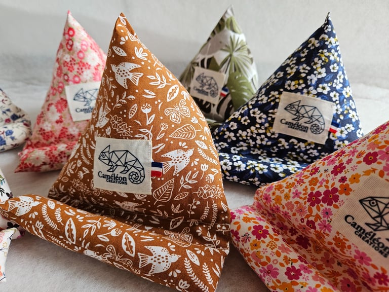 Handmade fabric pyramid phone stands in various floral and botanical patterns by Cameleon Creations.