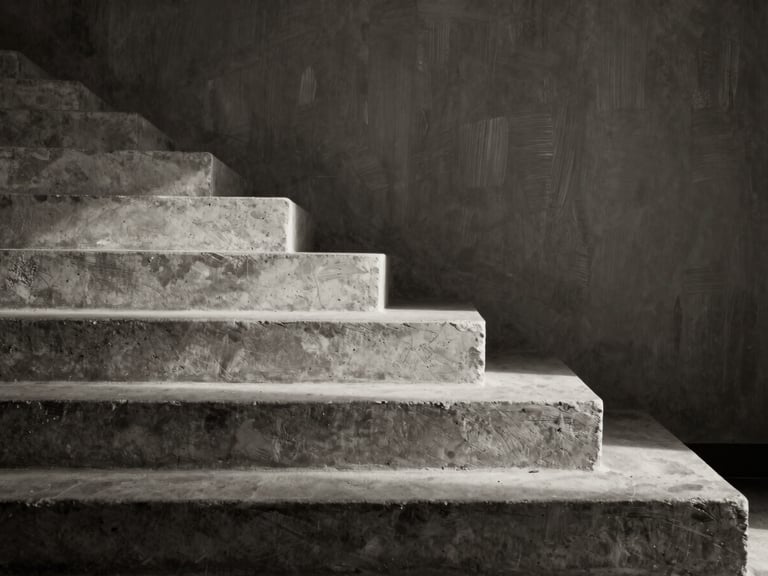 Monochrome architectural detail of concrete stairs casting shadow lines, dramatic side-lighting, deep shadows, textured brush background.
