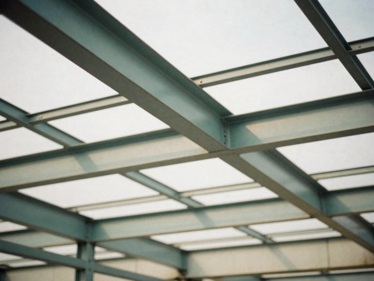 Architectural detail of structured steel beams casting sharp shadows in an industrial workspace, diffused overcast daylight, muted tones