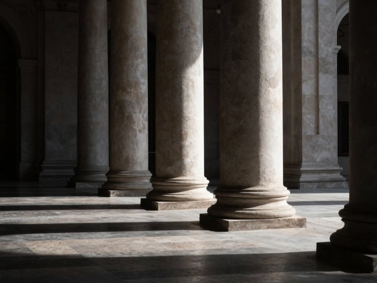 Wide-angle dramatic architectural crop of sunlit stone columns in a civic plaza, sharp directional window light, deep shadows, high contrast