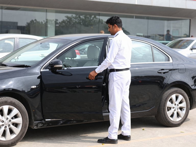 A professional chauffeur in clean attire opening the door of a polished black sedan at Bacha Khan International Airport, bright daylight, realistic colors.