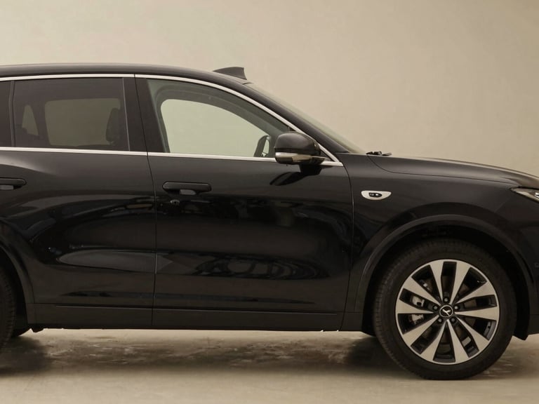 Side view of a modern black SUV parked in a professional setting, soft natural light, muted earth tones, high-end automotive, 35mm lens.