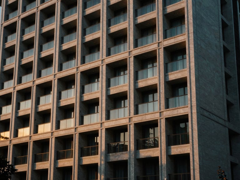 Architectural detail of a luxury resort facade, clean lines, golden hour light, reflecting precision and structure, cinematic editorial photography, golden-hour natural light, architectural composition.