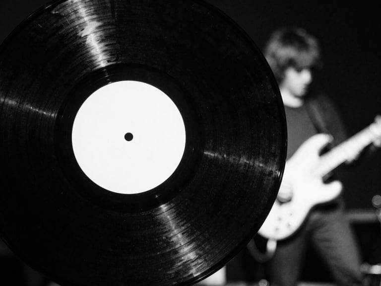 Close-up of a heavy-weight black vinyl record with a stark white label, slightly worn, against a dark, gritty background, high contrast, 35mm film grain.