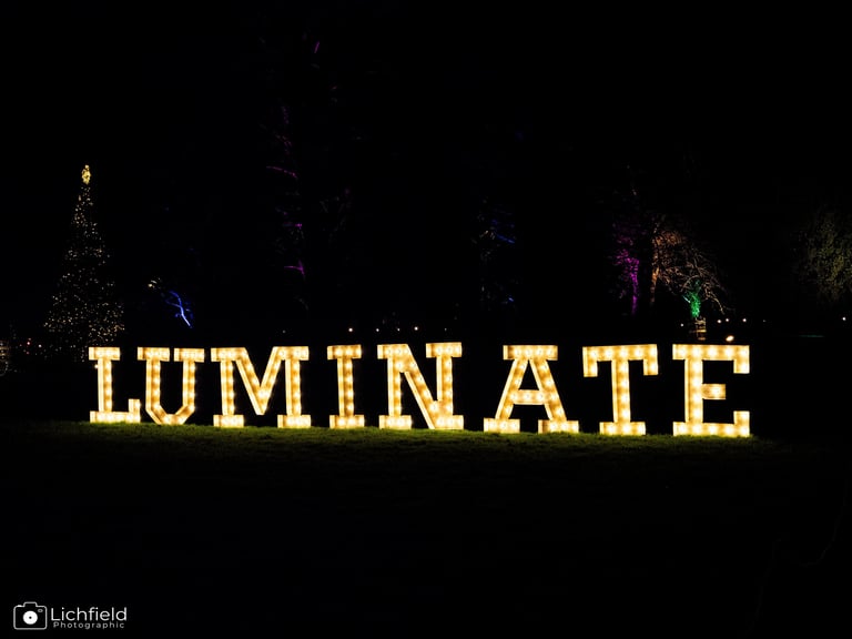 Luminate Image the words luminate in yellow against a dark background