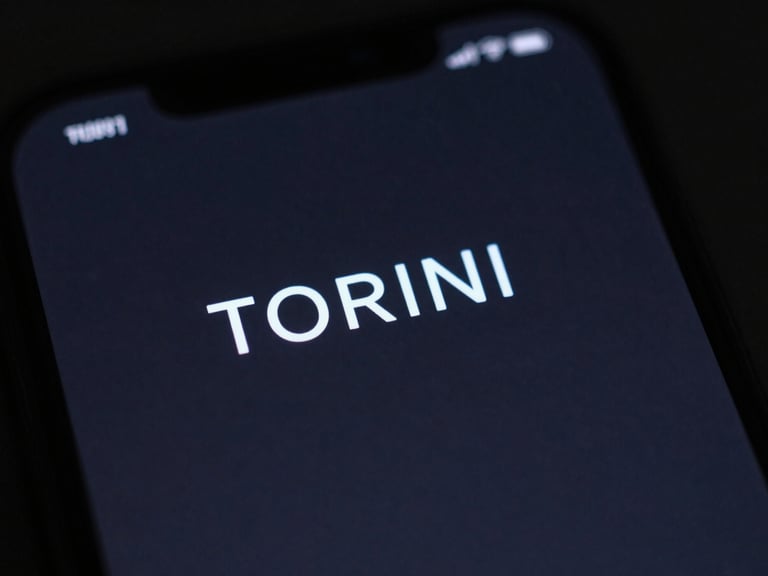 Macro close-up of a smartphone screen displaying a minimal TORINI launcher UI, deep charcoal background, electric blue accents, moody studio lighting.