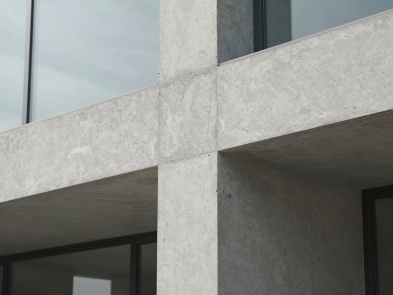 Macro detail of architectural textures, clean concrete and glass under soft natural light, minimalist composition, muted cool tones