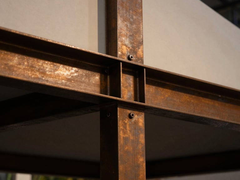 Extreme close-up of premium materials and architectural steel joints on a custom exhibition pavilion, dramatic warm lighting, deep shadows
