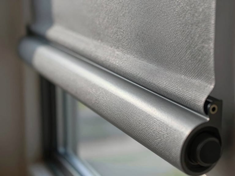Extreme close-up of a Mirage cellular shade mechanism and fabric edge, cool north daylight revealing the honeycomb texture, grey aluminium rail in sharp focus, shallow depth of field, luxury residential context