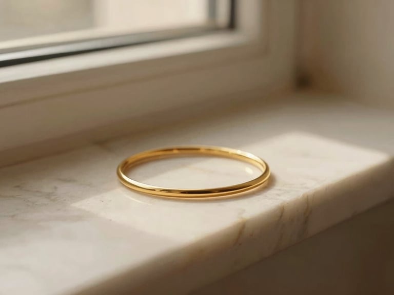 Extreme close-up of delicate gold jewelry resting on warm marble, soft shadows, quiet luxury aesthetic, 35mm