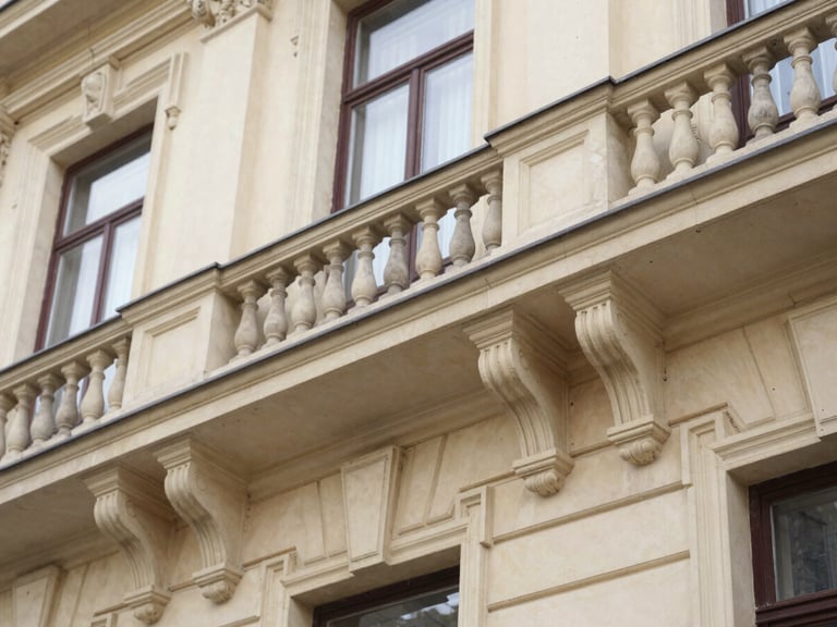 Architectural detail of a historic building on Cuza Vodă street, suggesting official institutions, soft natural daylight, deep navy and warm paper tones, macro lens, shallow depth of field